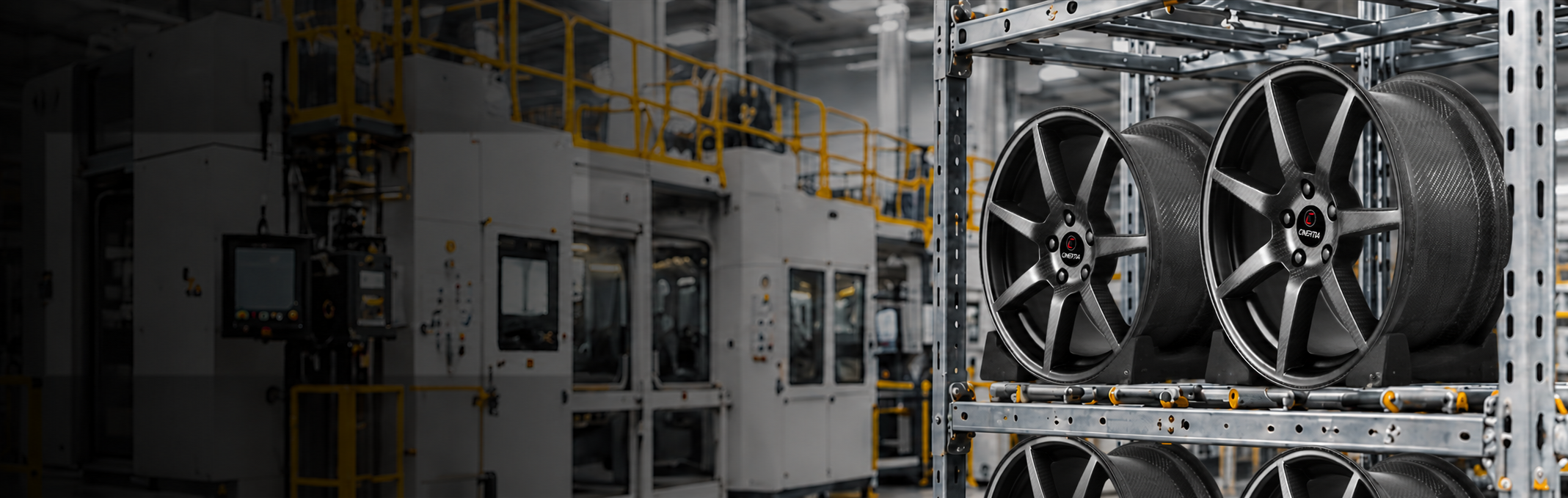 C-INERTIA carbon wheels on racks beside industrial production equipment